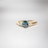 Daintree | 'Four Seasons' | Madagascan Teal Sapphire & Pear Diamonds Trilogy Ring made with 18K yellow gold in sunlight bottom up view