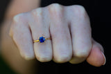 Solitaire Cushion Royal Blue Sapphire Ring on fist