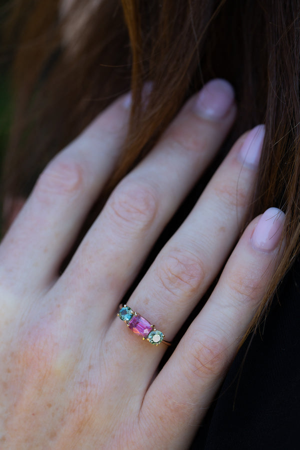 Vivid Pink & Forest Green Teal Sapphires Ring on engagement ring finger