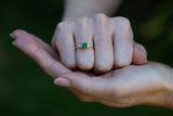 Emerald Green Tsavorite & Diamonds Ring on clenched fist