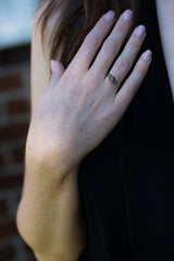Orange & Blue-Green Teal Sapphires Ring on engagement ring finger