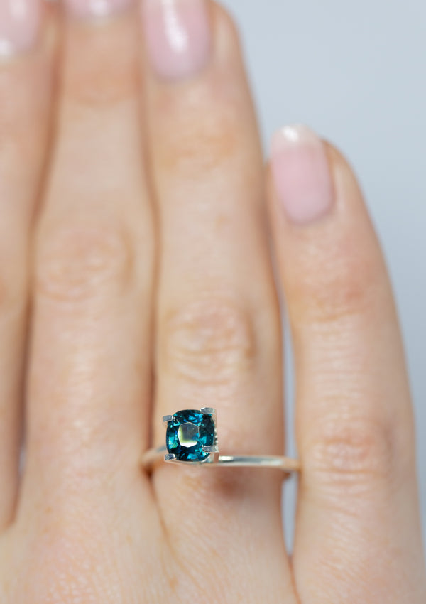 1.29Ct Blue Green Teal Sapphire | Cushion Shape from Madagascar on ring finger