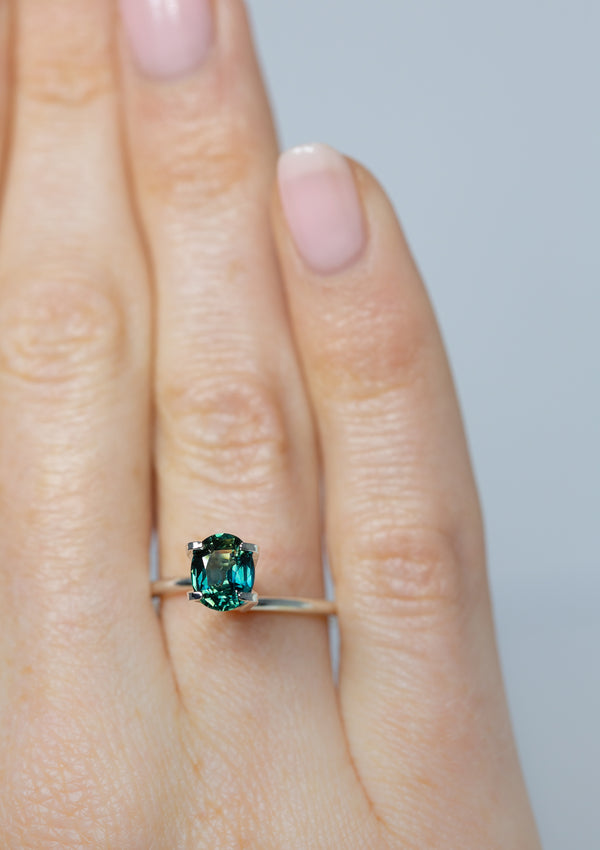 Close up of beautiful 1.31Ct Blue Green Teal Sapphire | Oval Shape from Madagascar on ring finger