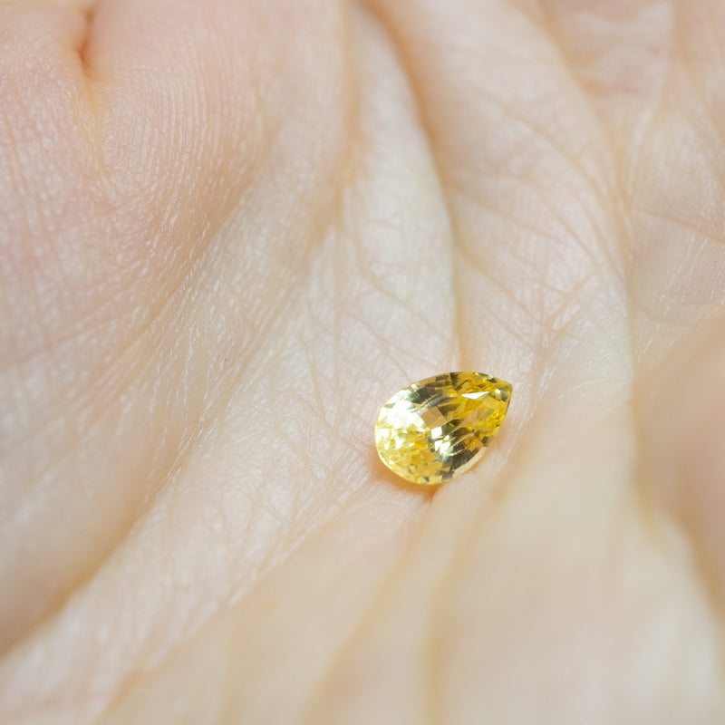 Natural, rare 1Ct Canary Yellow Sapphire | Pear Shape from Sri Lanka on palm