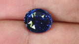 Video of Beautiful, rare 4.63Ct Vivid Blue Sapphire | Oval Shape from Sri Lanka between fingers
