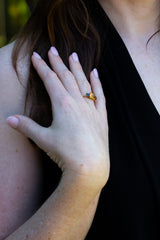 Golden Yellow Sapphire and dark spinel ring on engagement finger