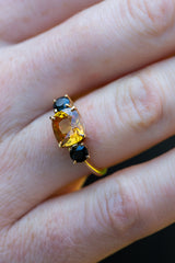 Golden Yellow Sapphire and dark spinel ring on finger