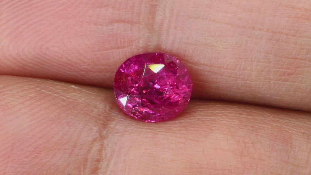 Video of 2.03Ct Hot Pink Sapphire | Oval Shape from Sri Lanka between fingers