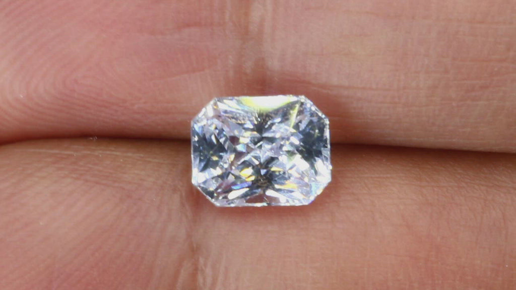 Video of 2.05Ct White Sapphire | Emerald Shape from Sri Lanka between fingers
