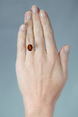 4.3Ct Deep Orange Brown Hessonite Garnet | Oval Shape on hand