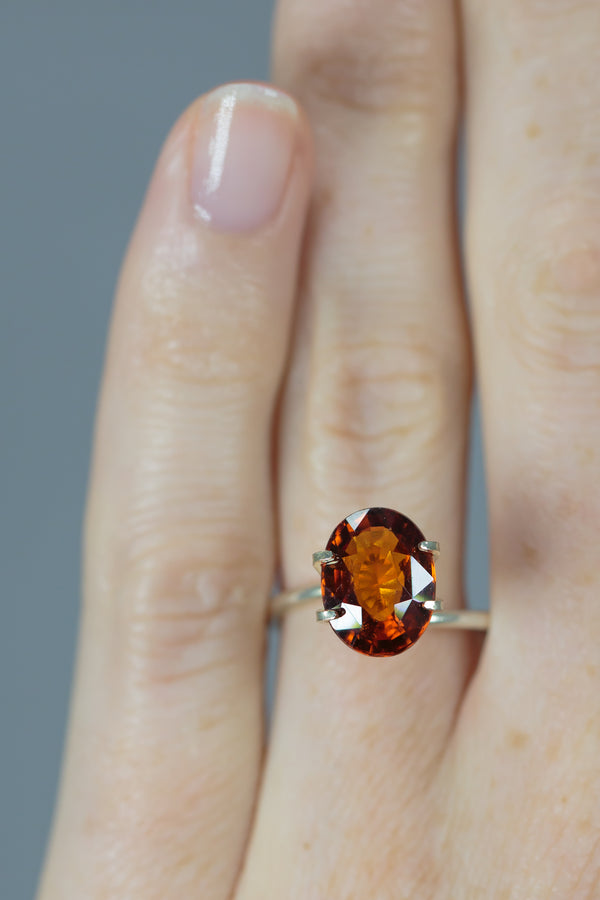 4.3Ct Deep Orange Brown Hessonite Garnet | Oval Shape on ring finger
