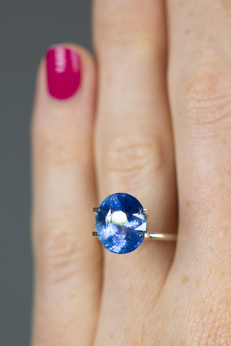 6.61Ct Blue Ceylon Sapphire | Oval Shape on ring finger