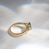 Daintree | 'Four Seasons' | Madagascan Teal Sapphire & Pear Diamonds Trilogy Ring made with 18K yellow gold in sunlight side profile