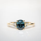 Daintree | 'Four Seasons' | Madagascan Teal Sapphire & Pear Diamonds Trilogy Ring made with 18K yellow gold in sunlight front closeup view
