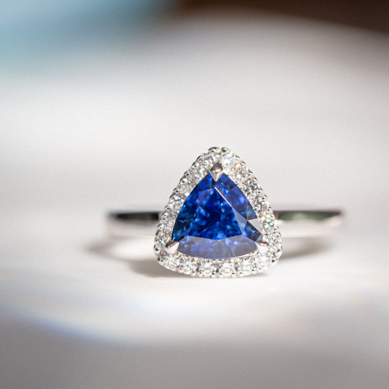 Indian Ocean | "Comoro Islands" | Natural Trillion Vivid Blue Ceylon Sapphire & Diamonds Halo Ring front view in macro and soft view