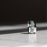 Indian Ocean | Paraiba Cluster - Neon Blue Paraiba Tourmaline & Diamonds Eternity Ring standing on the side