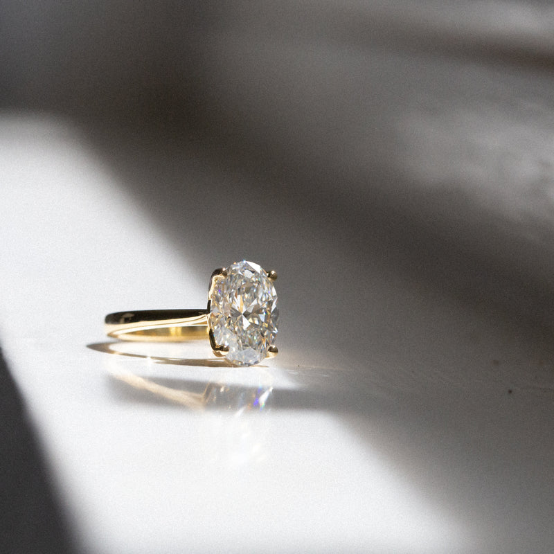Byron Bay | Classic Oval Solitaire - 3.3Ct GIA Certified D, VS1 Lab Diamond Ring in light at angle
