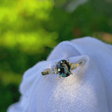 Daintree | 'Four Seasons' | Madagascan Teal Sapphire & Pear Diamonds Trilogy Ring made with 18K yellow gold in sunlight 