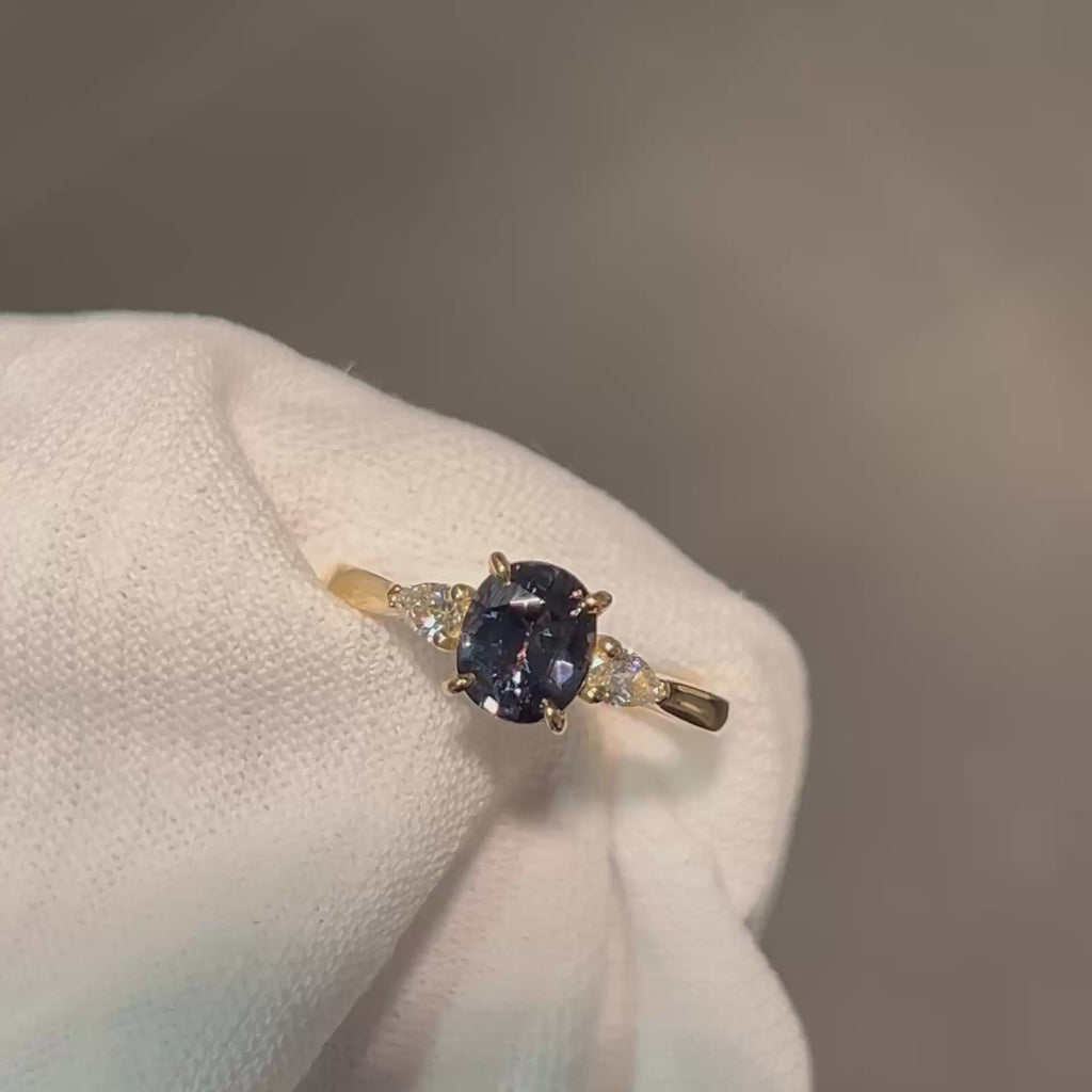 Daintree | 'Four Seasons' | Madagascan Teal Sapphire & Pear Diamonds Trilogy Ring made with 18K yellow gold in warm incandescent light