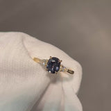 Daintree | 'Four Seasons' | Madagascan Teal Sapphire & Pear Diamonds Trilogy Ring made with 18K yellow gold in warm incandescent light