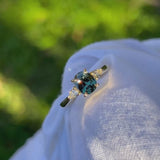 Daintree | 'Four Seasons' | Madagascan Teal Sapphire & Pear Diamonds Trilogy Ring made with 18K yellow gold in sunlight 2