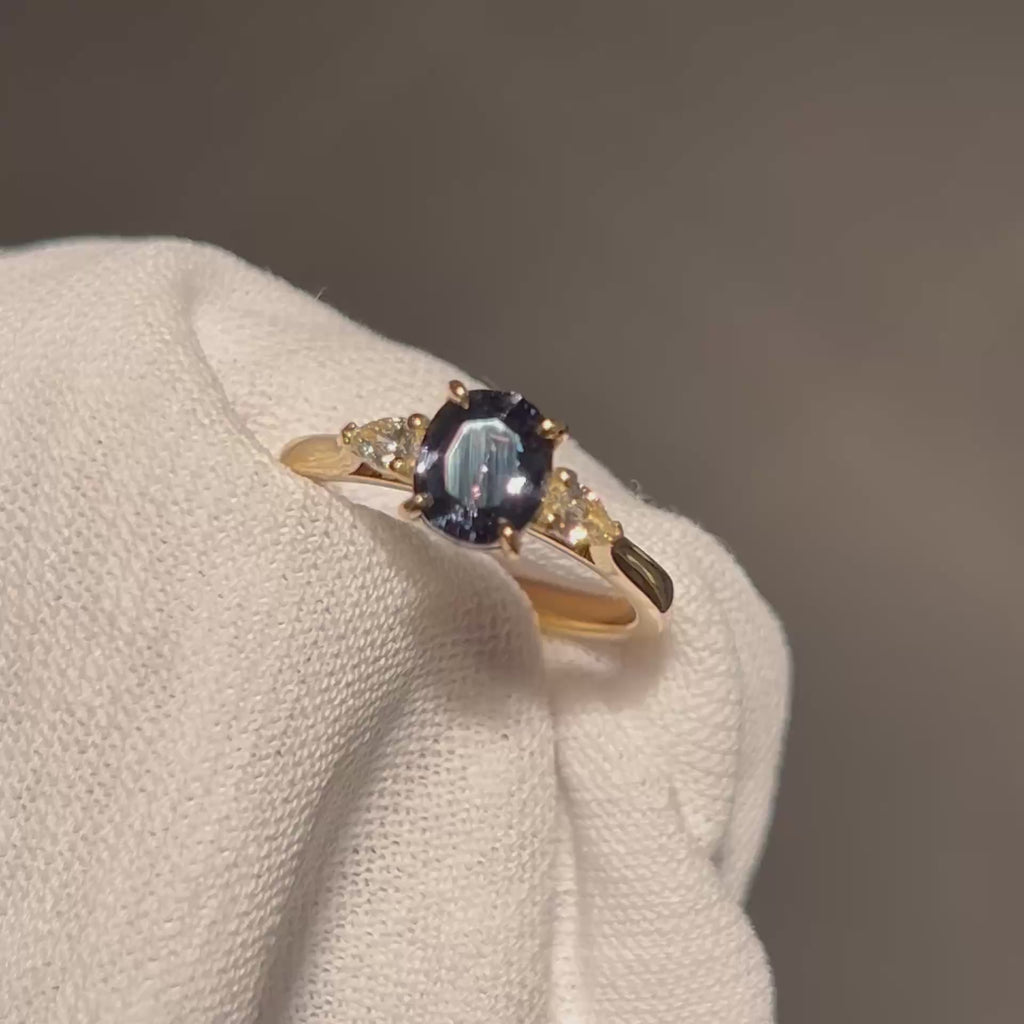 Daintree | 'Four Seasons' | Madagascan Teal Sapphire & Pear Diamonds Trilogy Ring made with 18K yellow gold in warm incandescent light