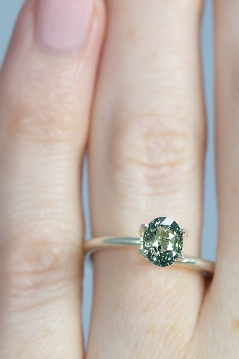 1.25Ct Light-Medium Blue Green Madagascan Sapphire | Oval Shape on finger