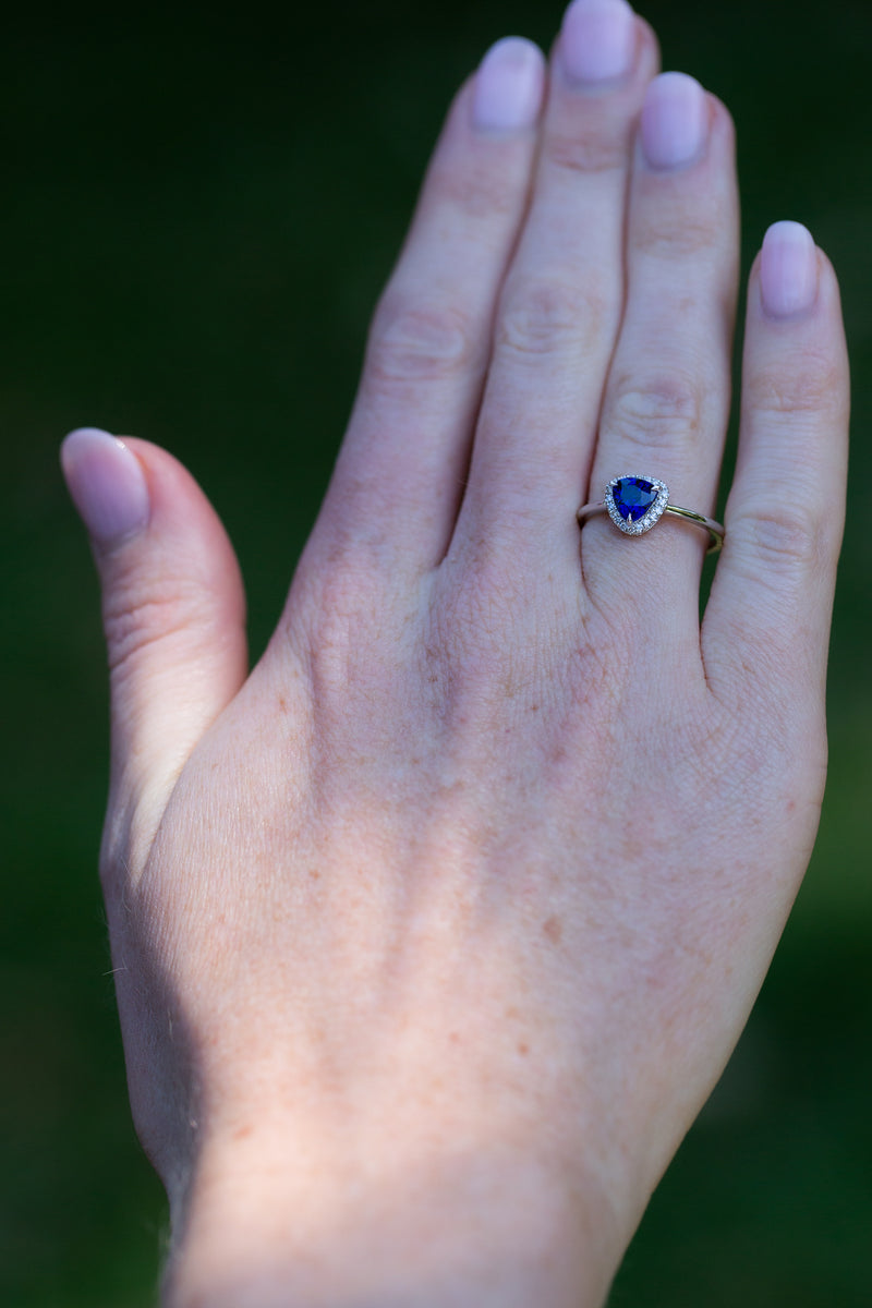 Royal Blue Trillion Sapphire & Diamonds Ring on engagement ring finger