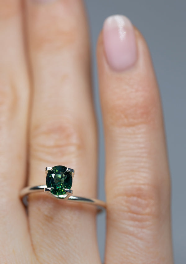 Immersive 1.31Ct Blue Green Teal Sapphire | Oval Shape from Madagascar on ring finger