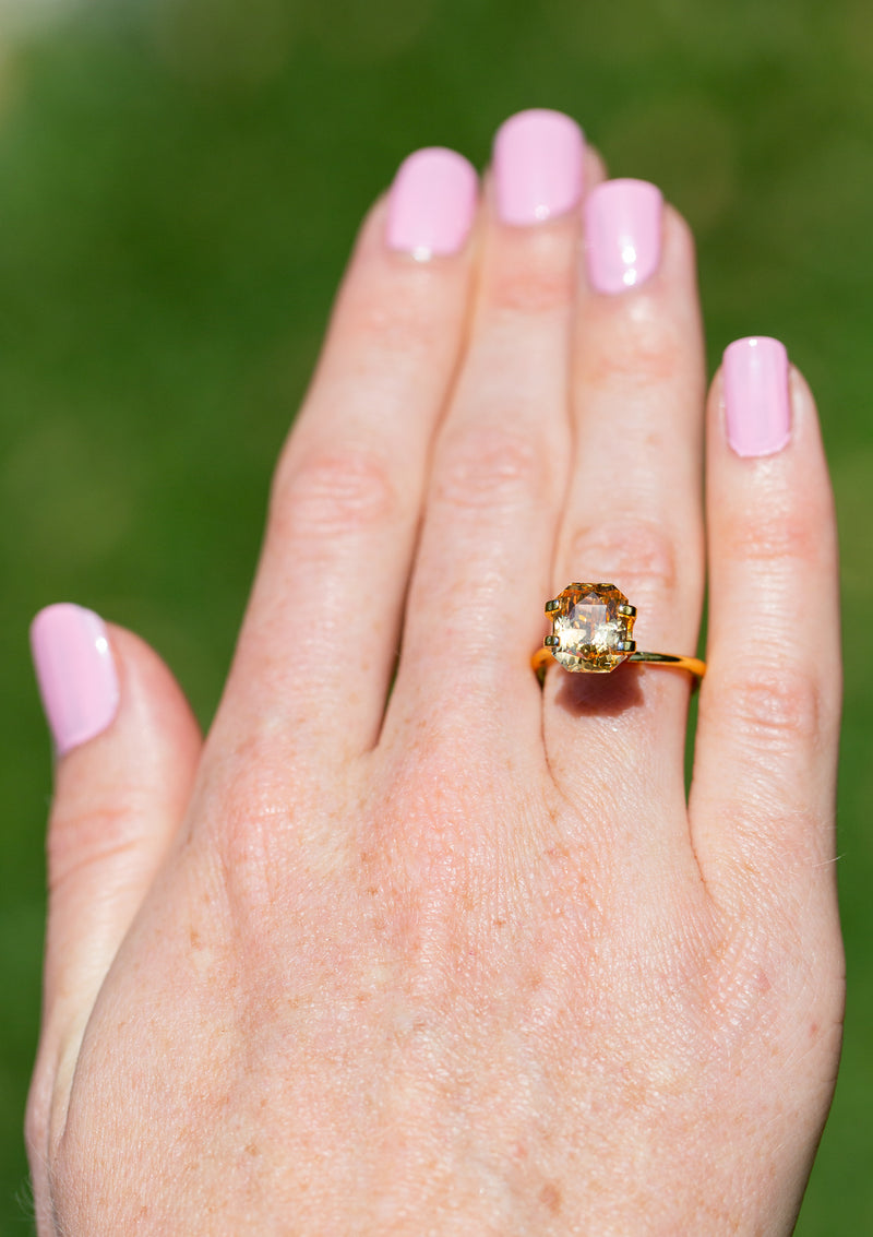 4.56CT Unheated Peachy Yellow Ceylon Sapphire on ring finger