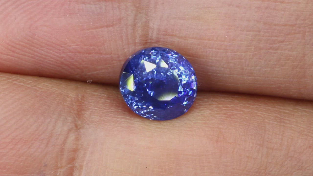 Video of Beautiful 2.52Ct Cornflower Blue Sapphire | Oval Shape from Sri Lanka between fingers